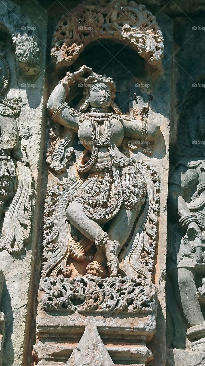 Halebeedu Hoysaleeswara temple sculptures represents a young lady performing an abhinaya