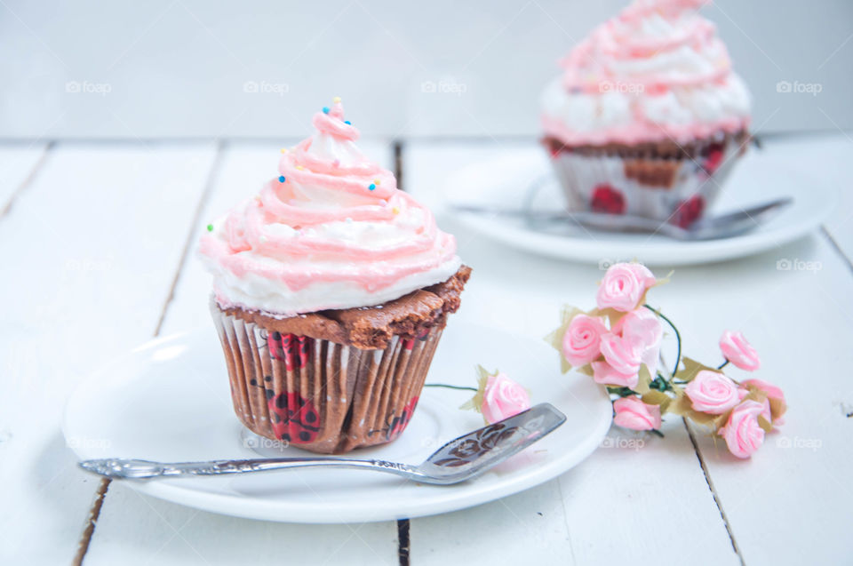 Two pink cupcake on plate