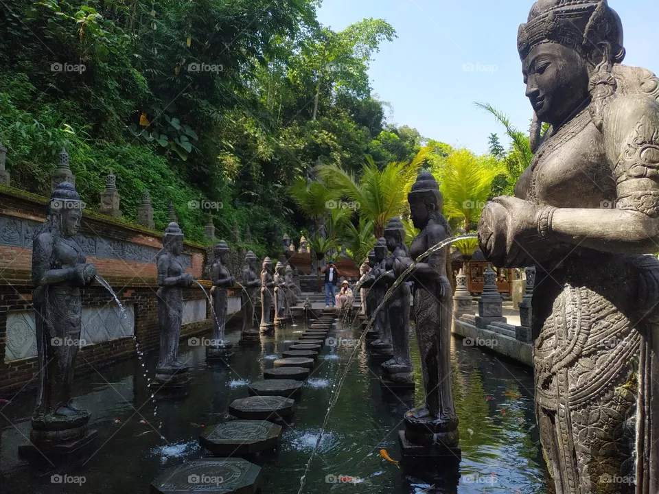 Several statues of goddesses carrying jugs filled with water