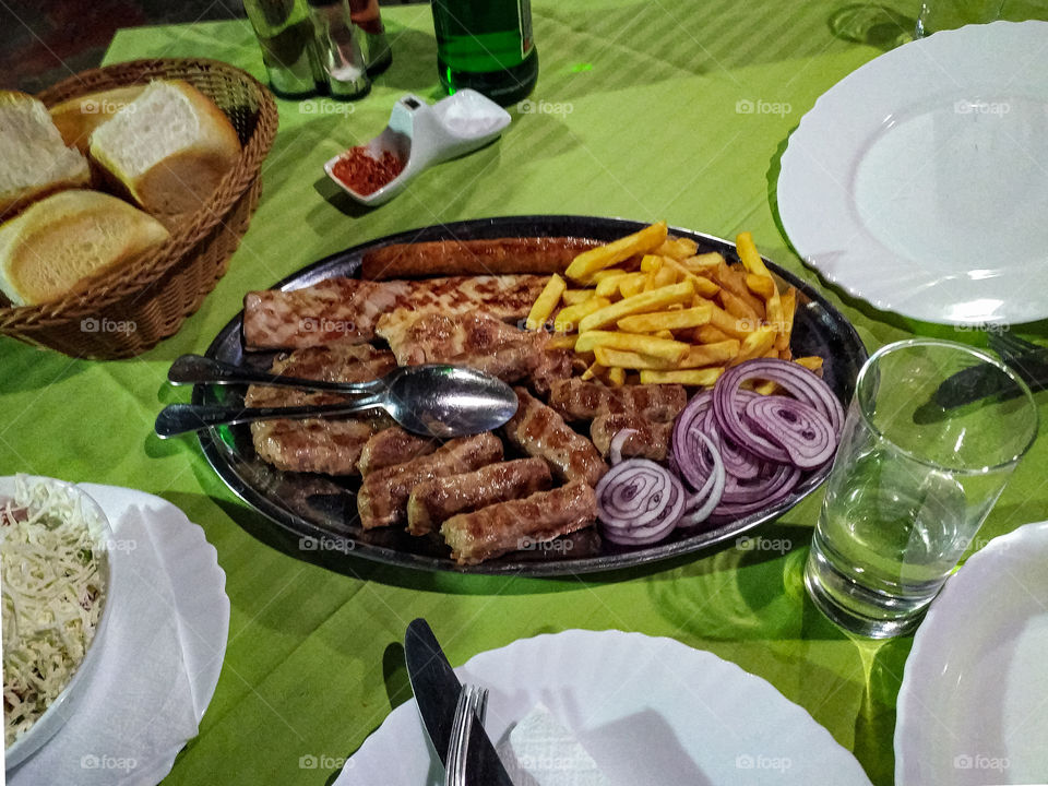 Mixed barbecue meat, and french fries