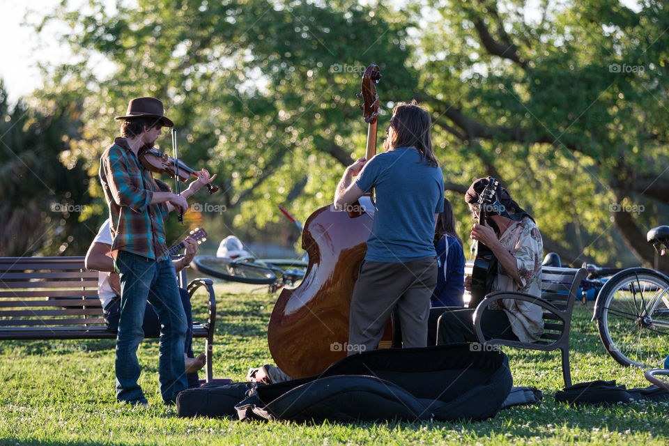 Musician artist playing music instrument in the park