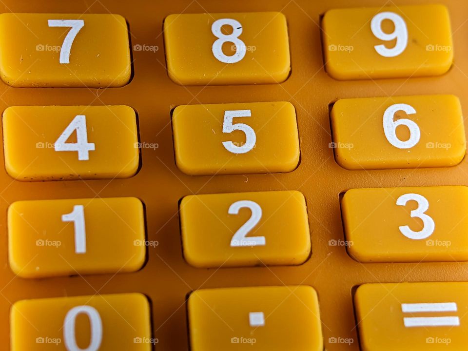 Closeup orange calculator with rectangle shape button number.