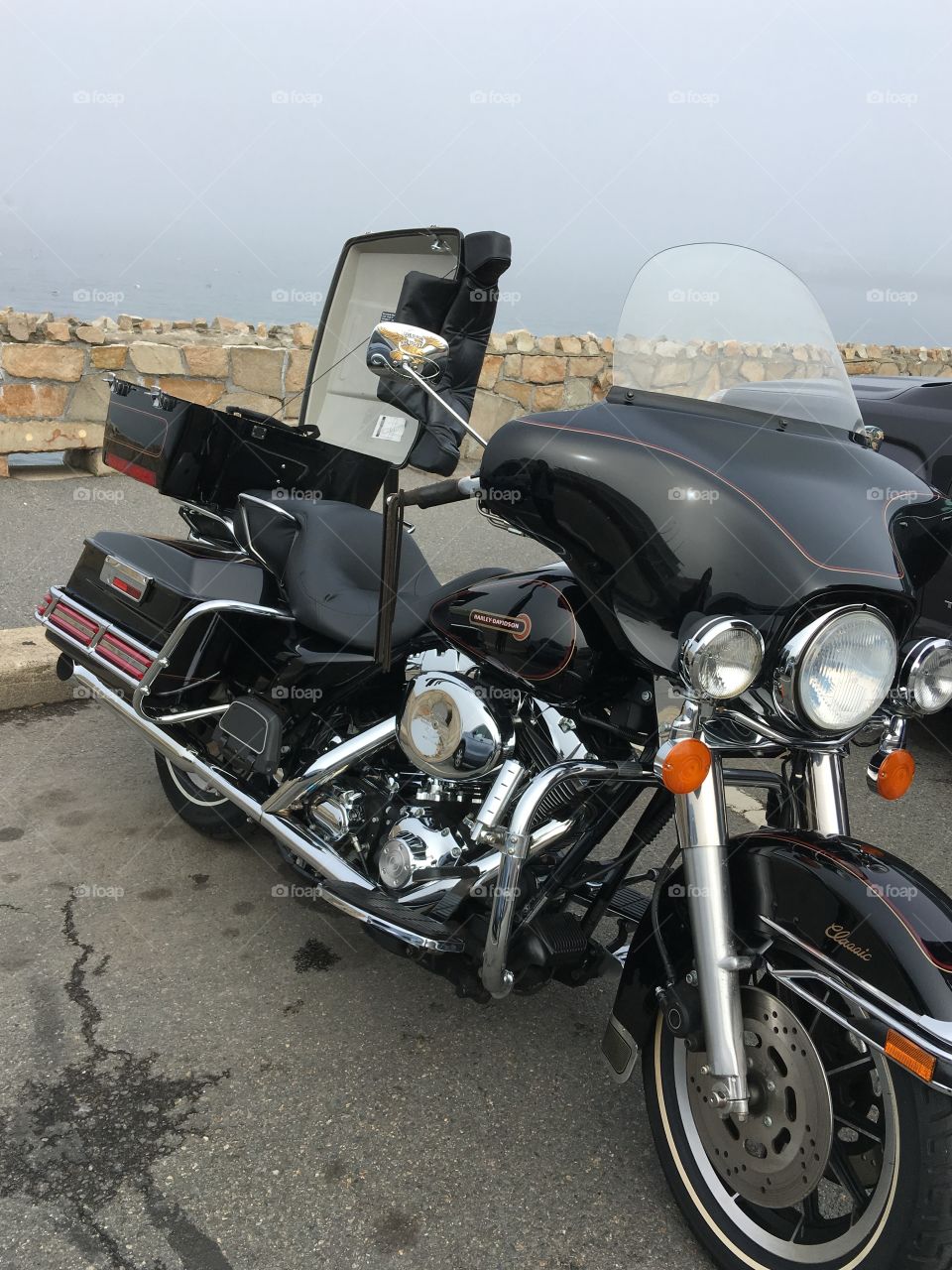 Harley Davidson Dresser, trunk open, getting ready to continue our ride. Plymouth, MA tourist beach is still covered in fog!