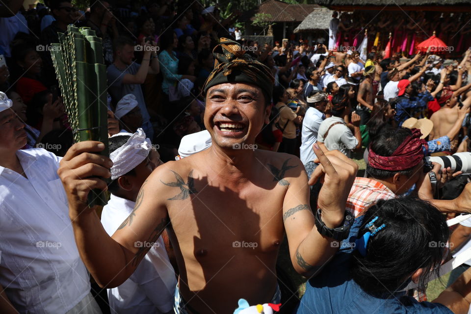 A Balinese man laughs ahead of his participation in the annual perang pandan festival when men fight each other with thorny pandan leaves, in the village of Tenganan in Bali, Indonesia.