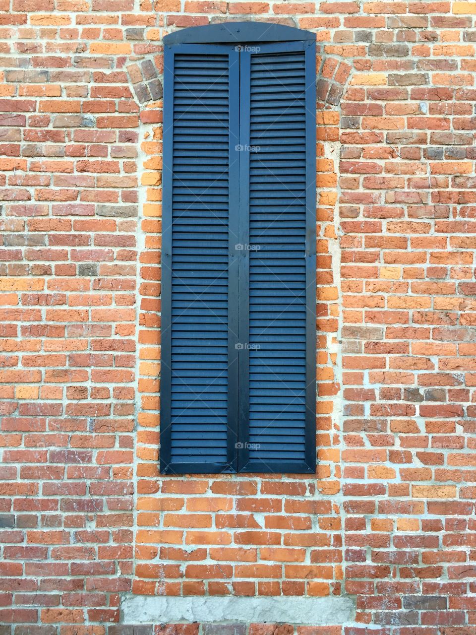 Black Shutter on Brick Wall