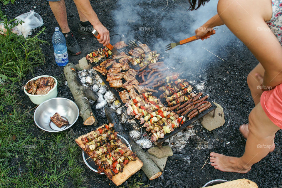 Assorted meat and vegetables on barbevue grill cooked for friends