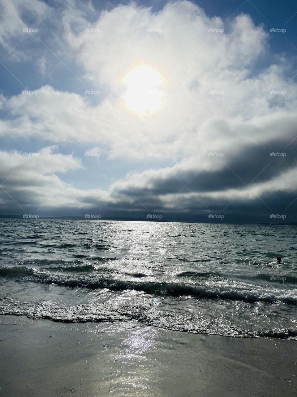 Beautiful sunset. Dark clouds rising. Waves crashing. 