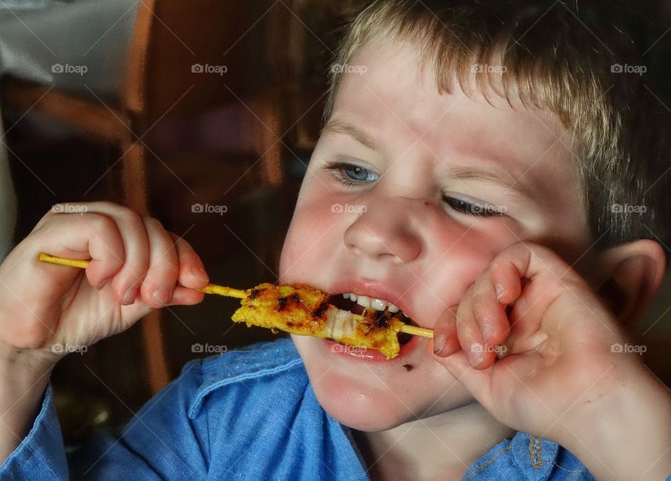 Boy Chewing Meat