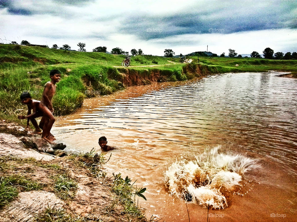 boys jumping on water