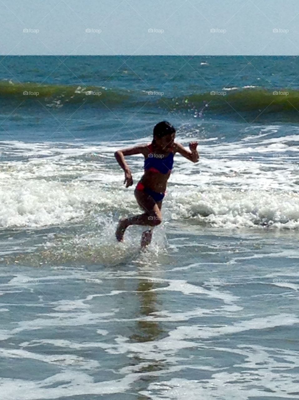 Girl running in the surf