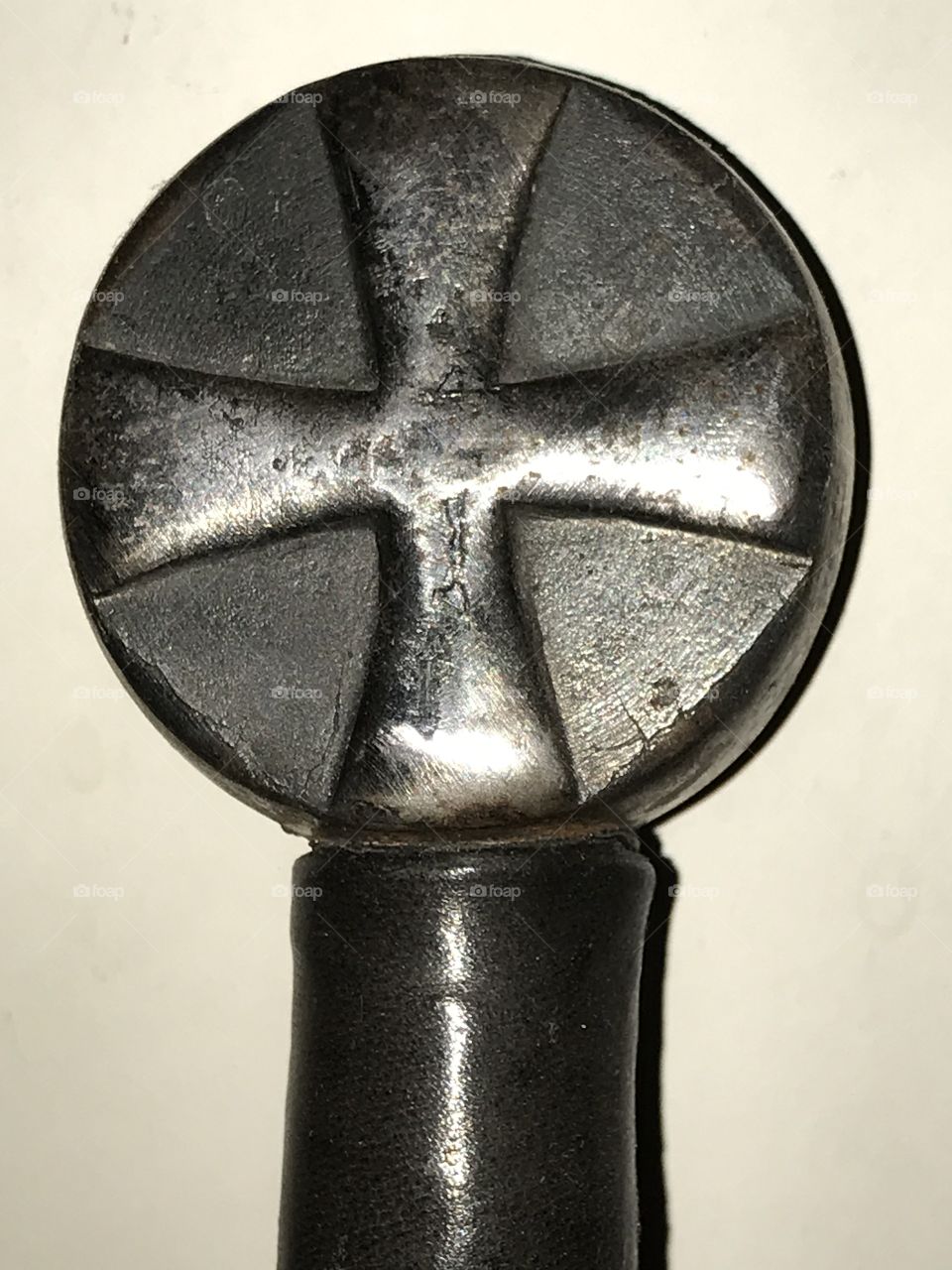 The pommel of a Crusader longsword. This work of art bears the iconic Christian cross that symbolizes their faith the knights of Christ fought for.