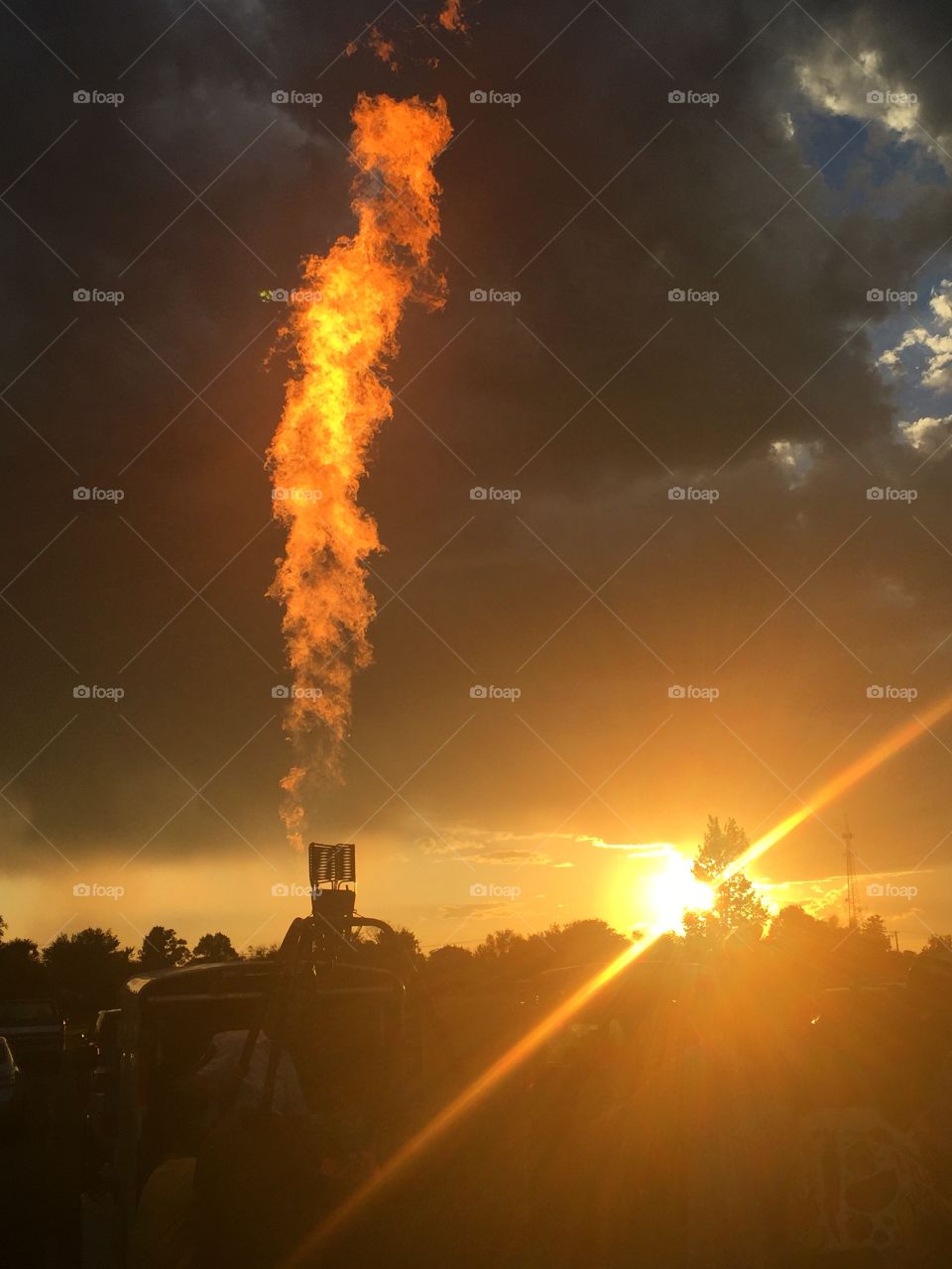 Hot air ballon basket firing before sunset 