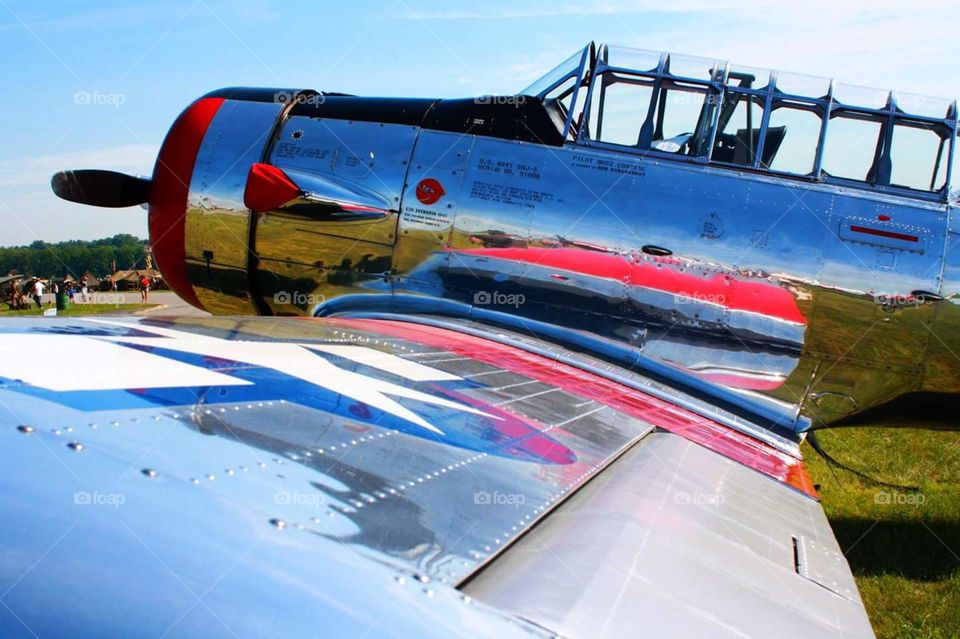 chrome airplane with reflections of bright colors