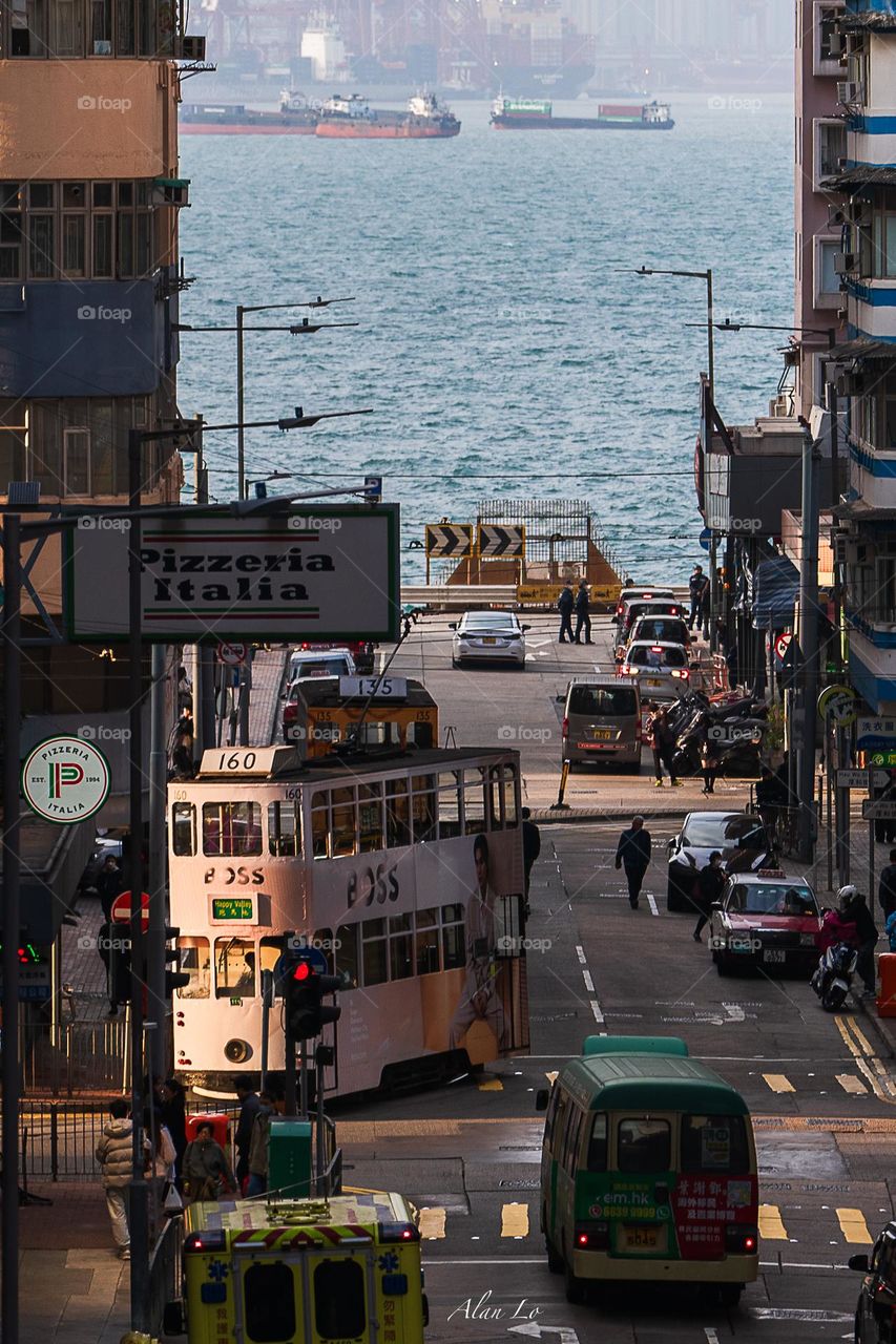 Tram running on the seaside during sunset