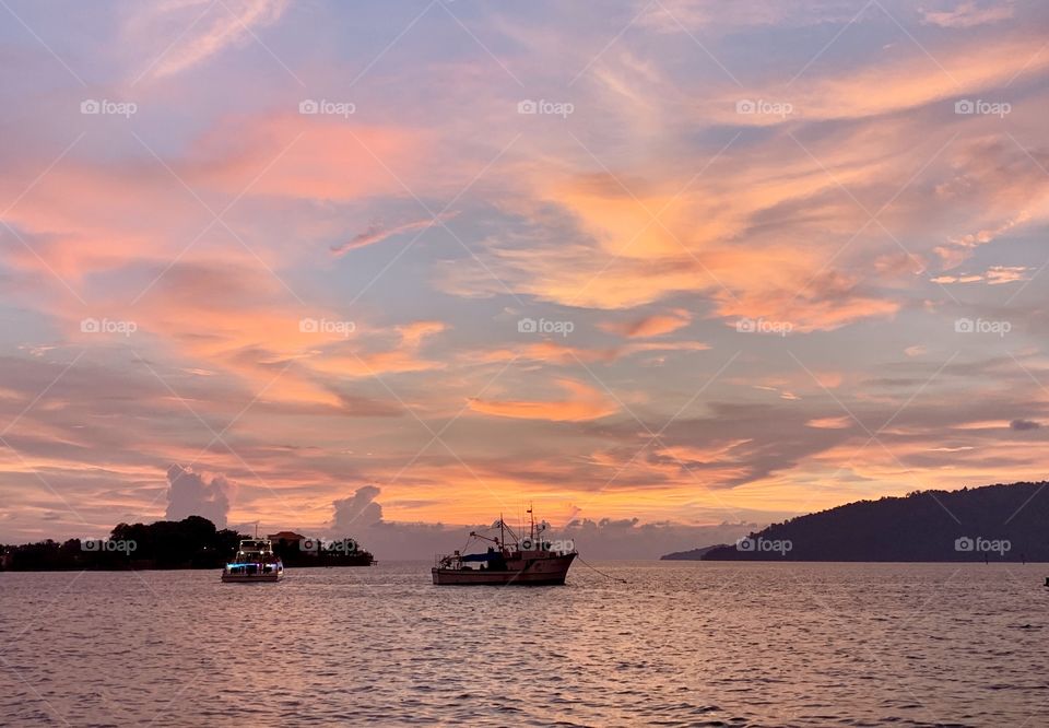 Silhouettes of ships in Kota Kinabalu, Malaysia. 