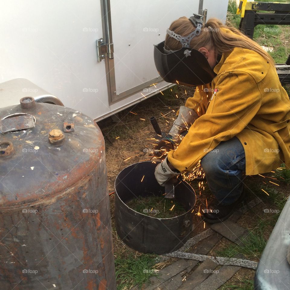 Weld. A man cutting welding and metal working 