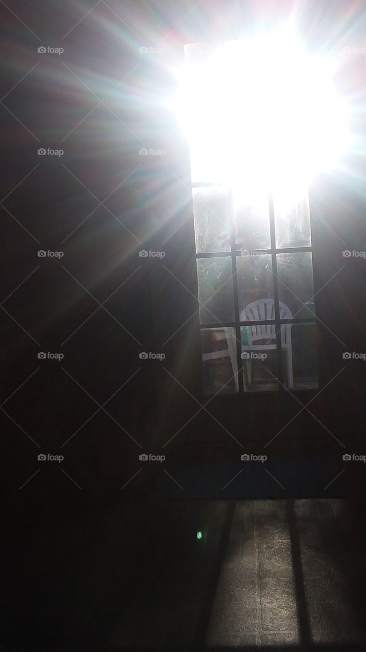 sunset through the door casting its Ray's with shadow and light