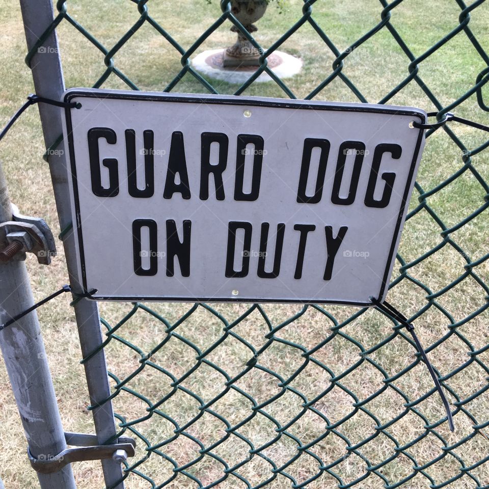 Guard Dog On Duty sign on chain link fence door!