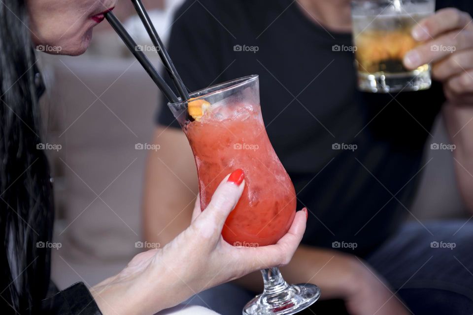 Red summer soft drink in glass goblets.