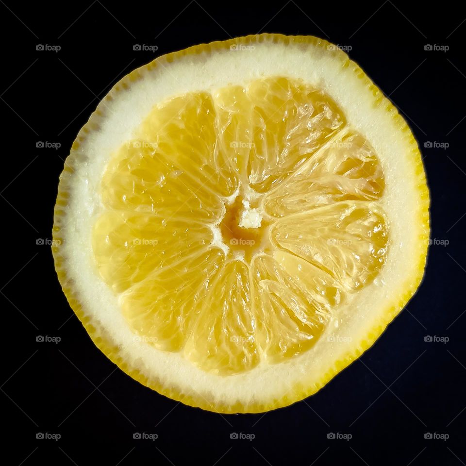 Sliced lemon on black background