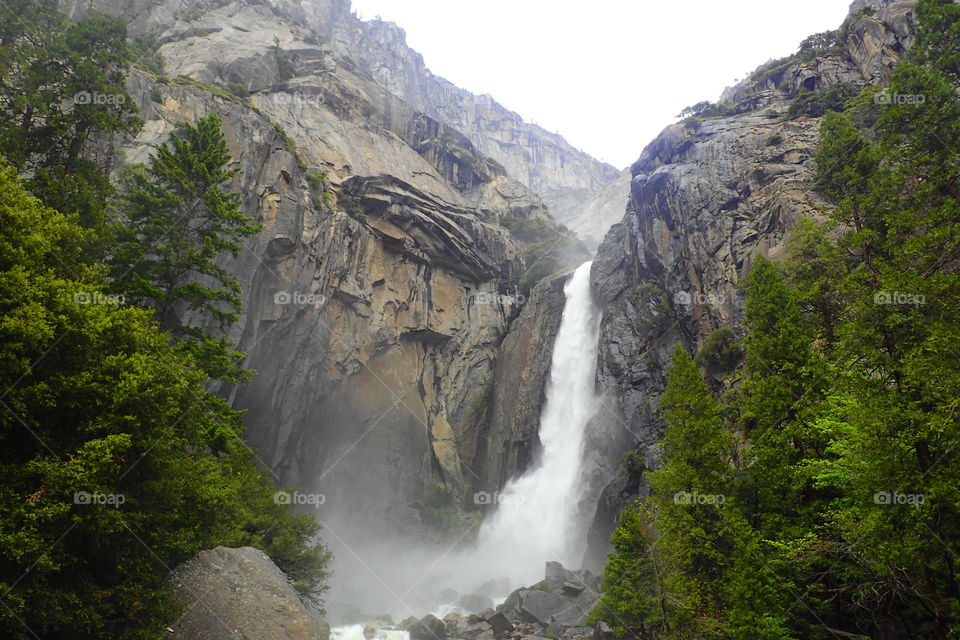 enjoying the view of a huge waterfall at Yosemite national park.