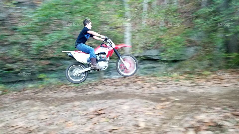 son jumping his dirt bike