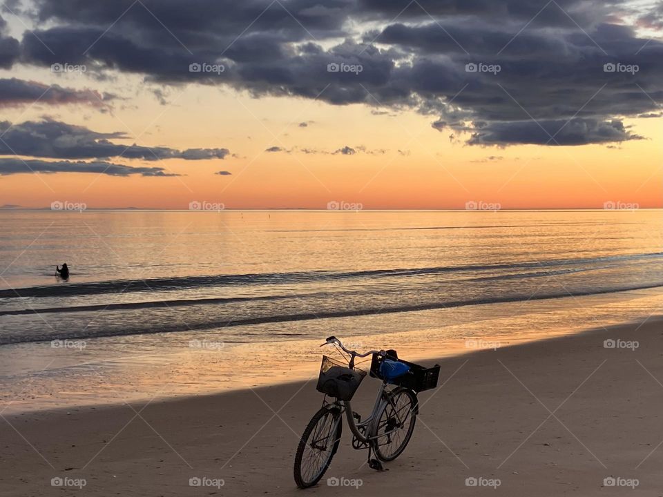 Seashore with clouds and bicycle 