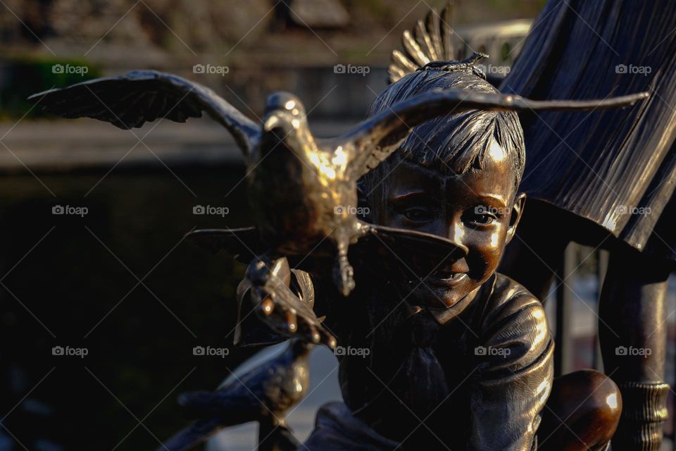 Sculpture of a boy and a bird