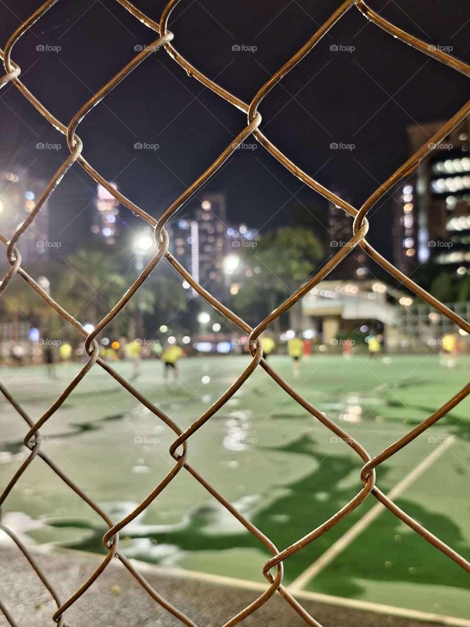 Men playing soccer after the rain at Hong Kong Victoria Park
