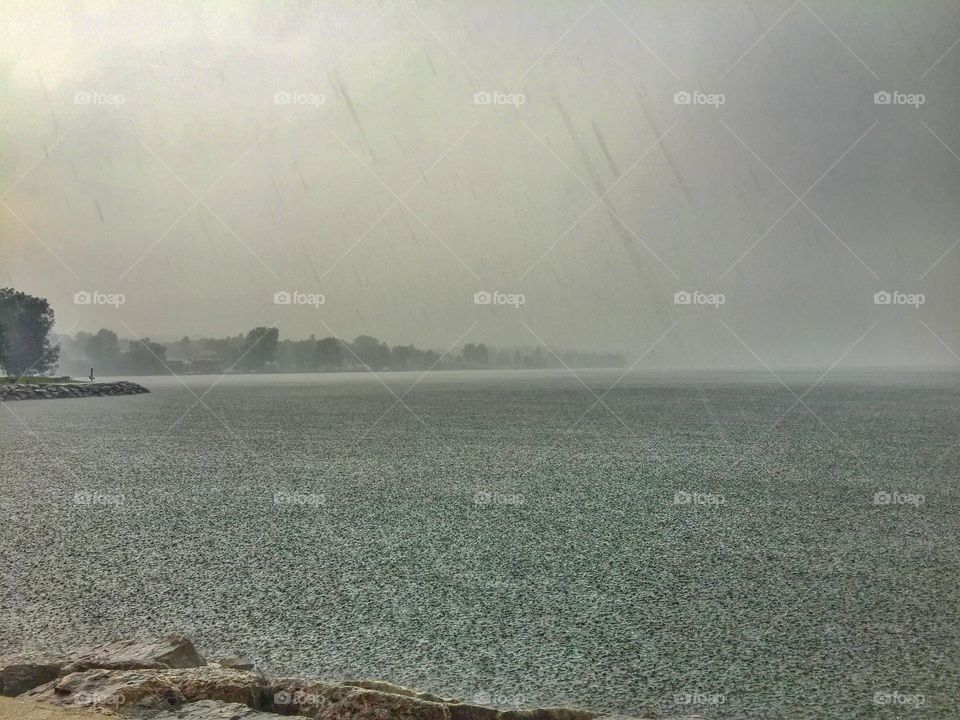 Storming on the lake . Downpour 