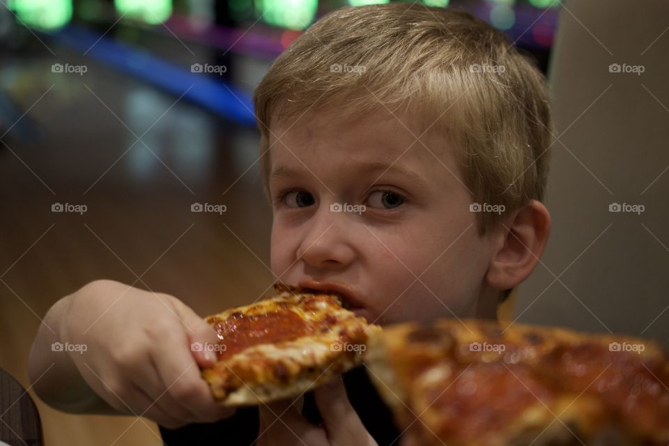 Boy enjoying his pizza 