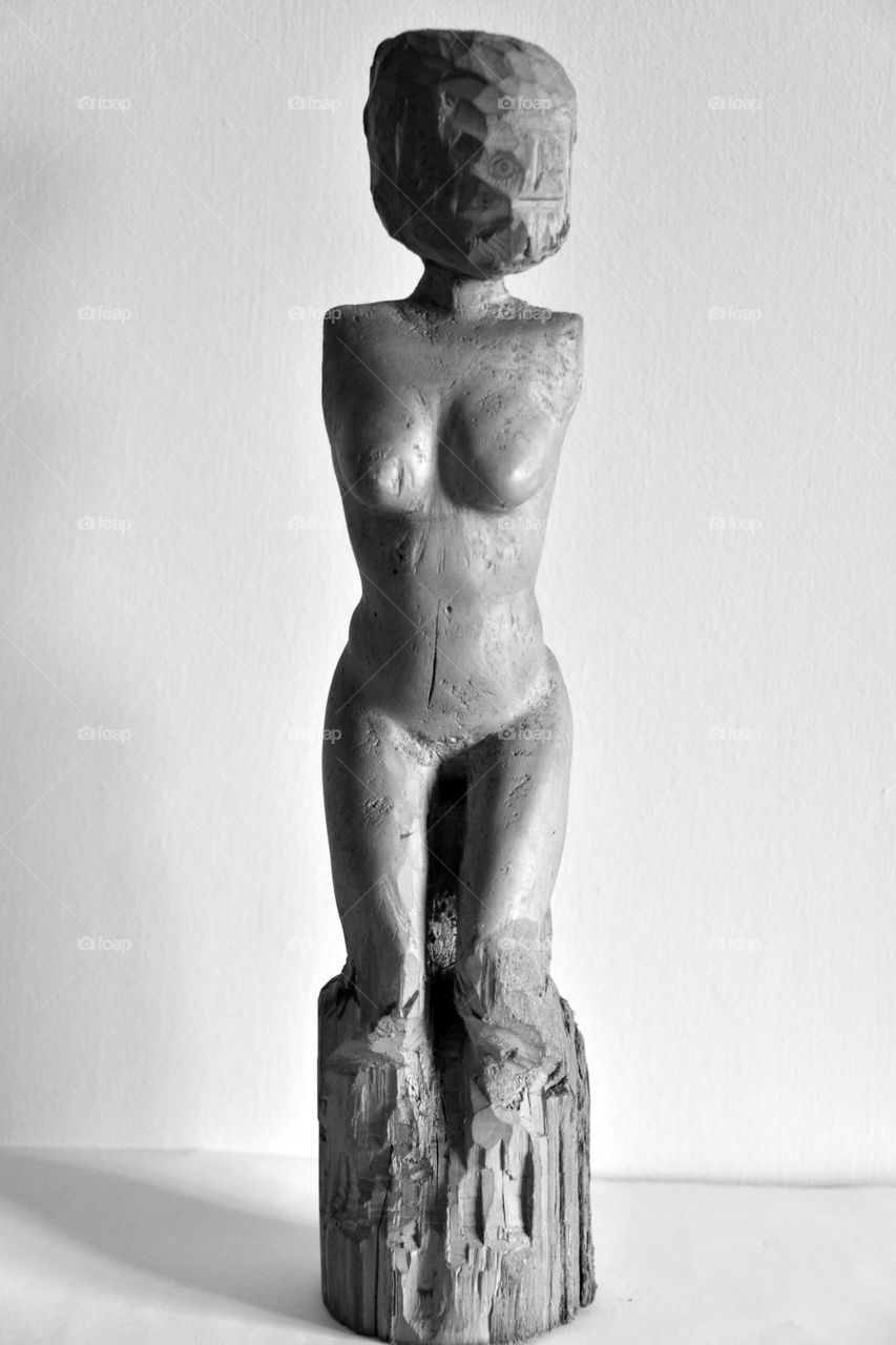 naked body of a woman, wood carving