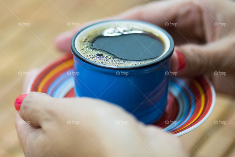 Woman hand holding cup of coffee
