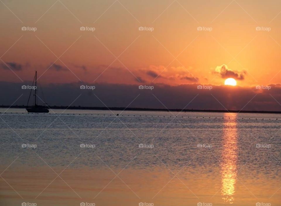 sea water boat sky sun sunset