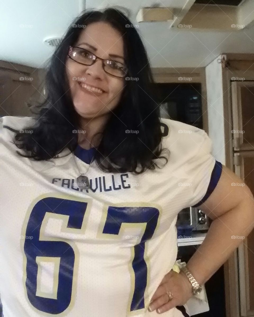 Mom trying to embarrass teenage son by wearing his football jersey 