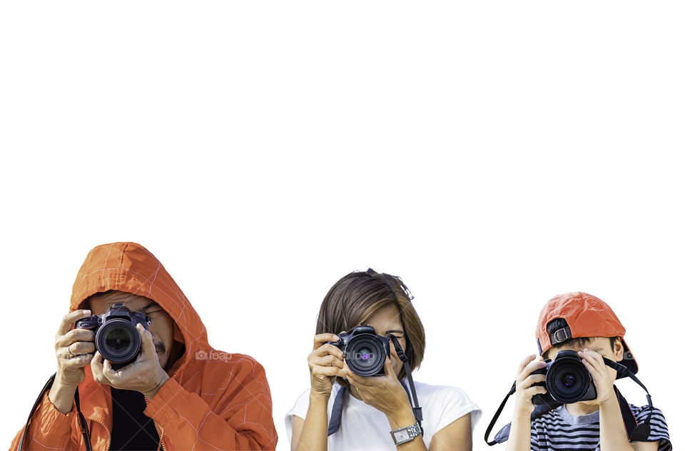 Hand man , woman and boy holding the camera Taking pictures on a white background.