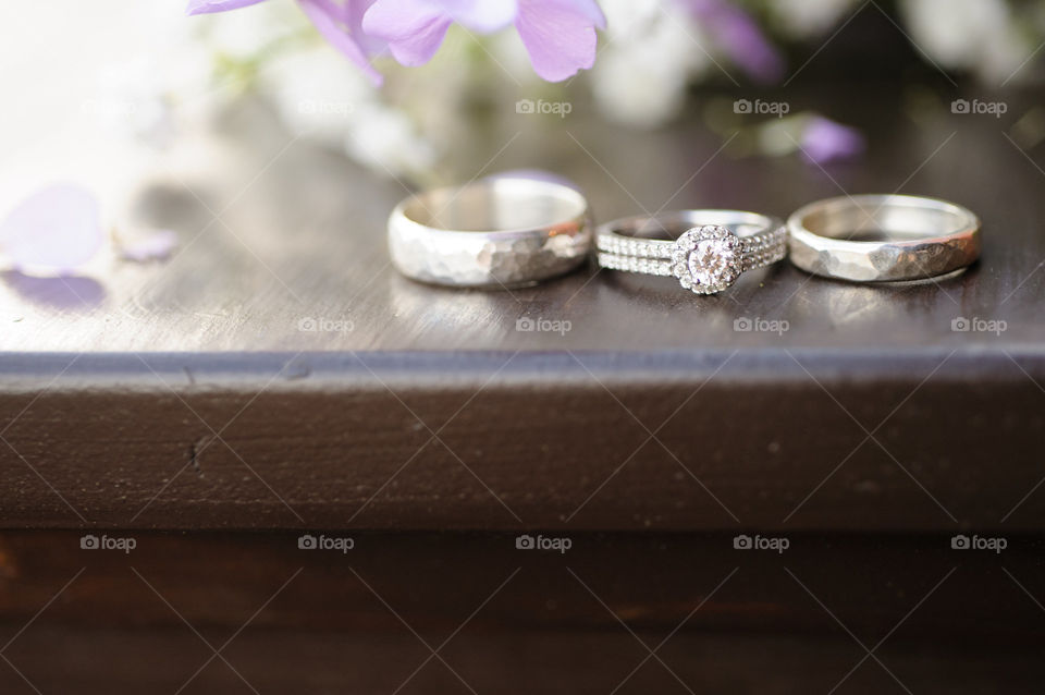 Beautiful Set of Three Silver Wedding Rings - Halo Diamond Engagement Ring and Bands - Closeup Jewelry Photography Still Life