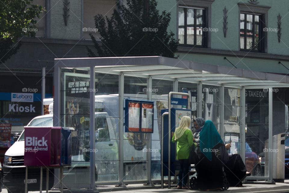 Street Shot Of Women At A Tram Stop