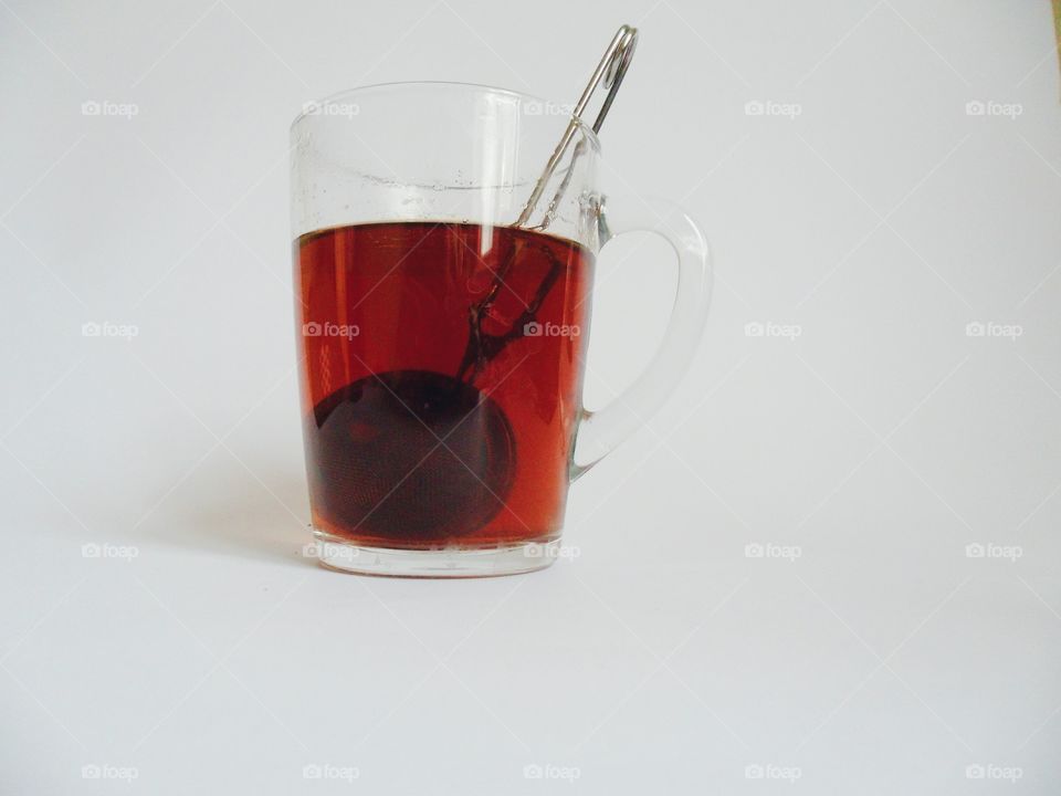 Cup of black tea on a white background