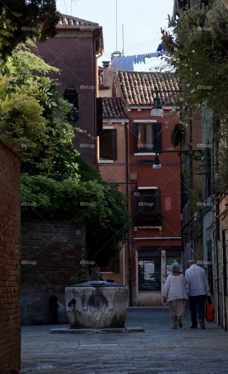 Couple holding hands in Venice Italy. LOVE 