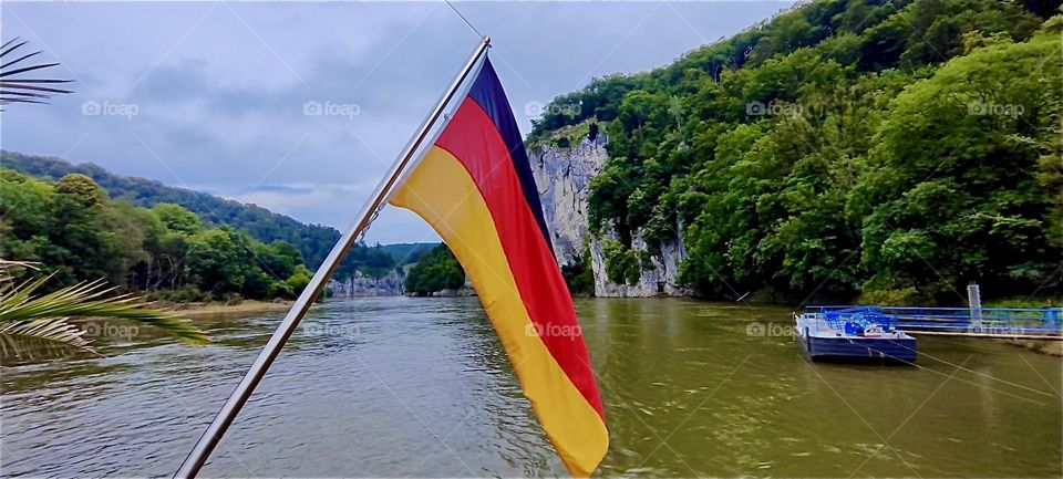 Old style fisher row boats called “Zillen” give day tours on the “Danube” between “Kelheim” and the “Weltenburg Abbey” in “Bavaria”, Germany where the river makes two narrow turns. The flag shows the vessel’s nationality. 2024. Hypnotic Productions