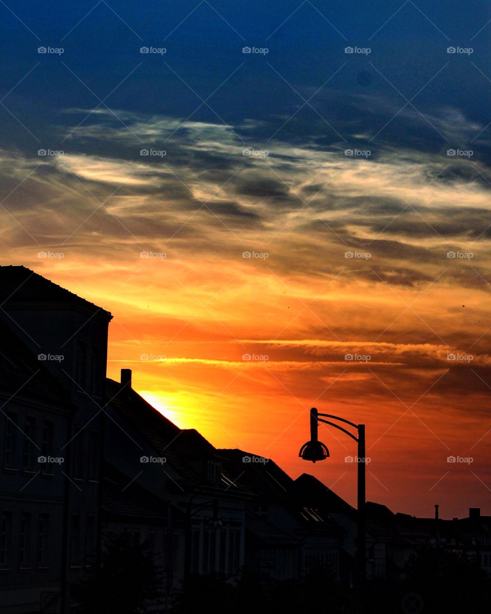 Summer sunset in a small town of northern Germany. The sun was feeling shy, and i had to capture its beauty before he retrieve to his sleep.