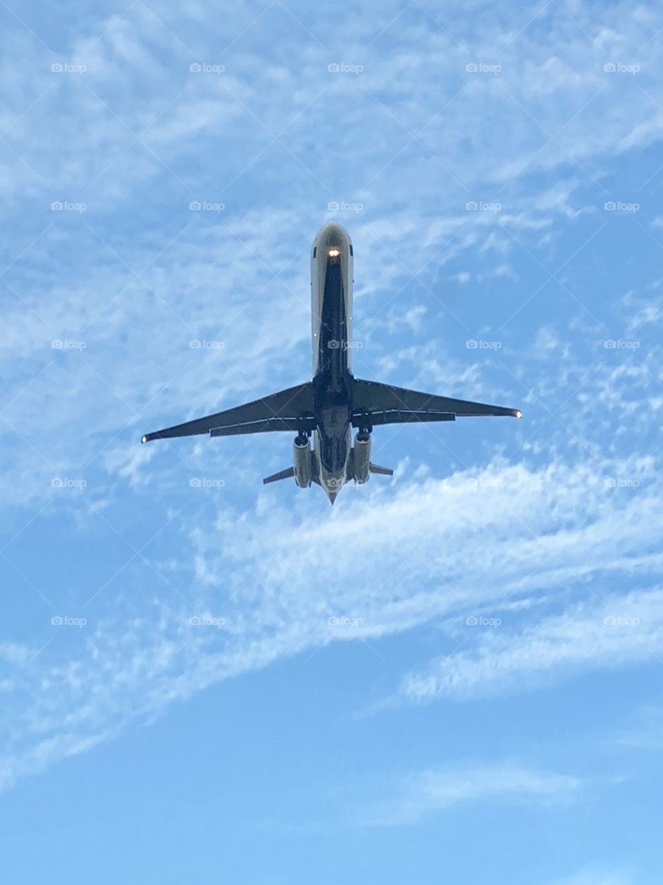 Sliding earthwards from smooth skies, a jet throttles back to glide swiftly towards evening’s curtain fall.