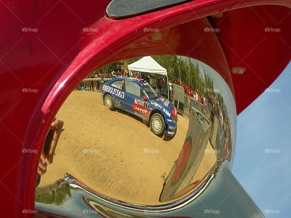 rally car reflexion by fireman safety helmet