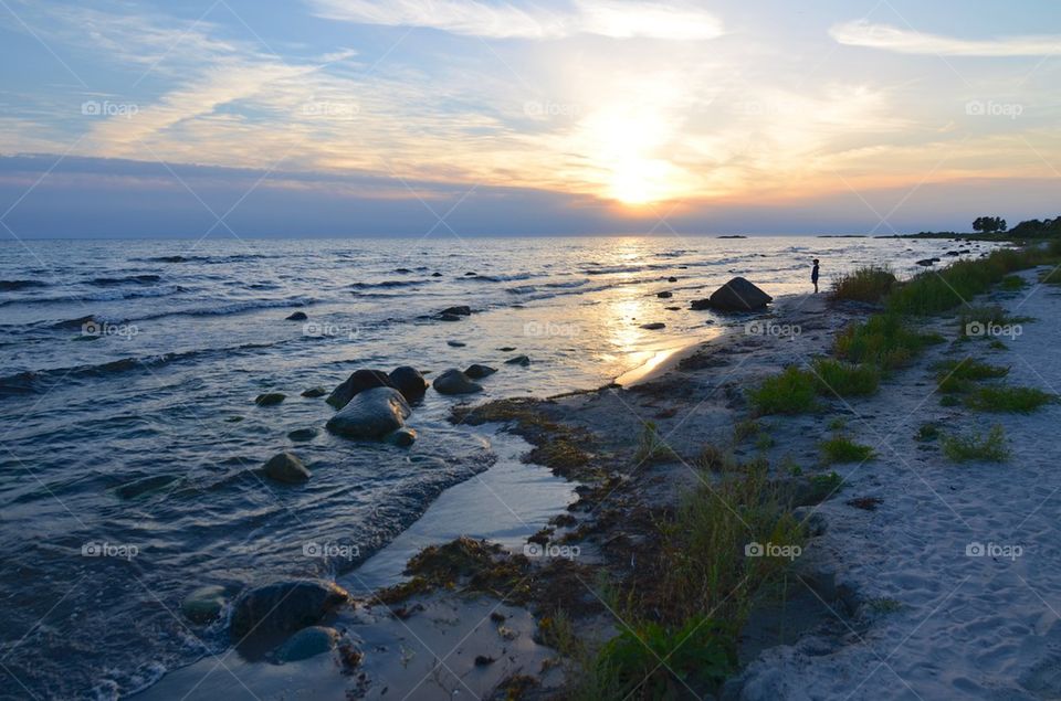 Boy watching Sunset on beach