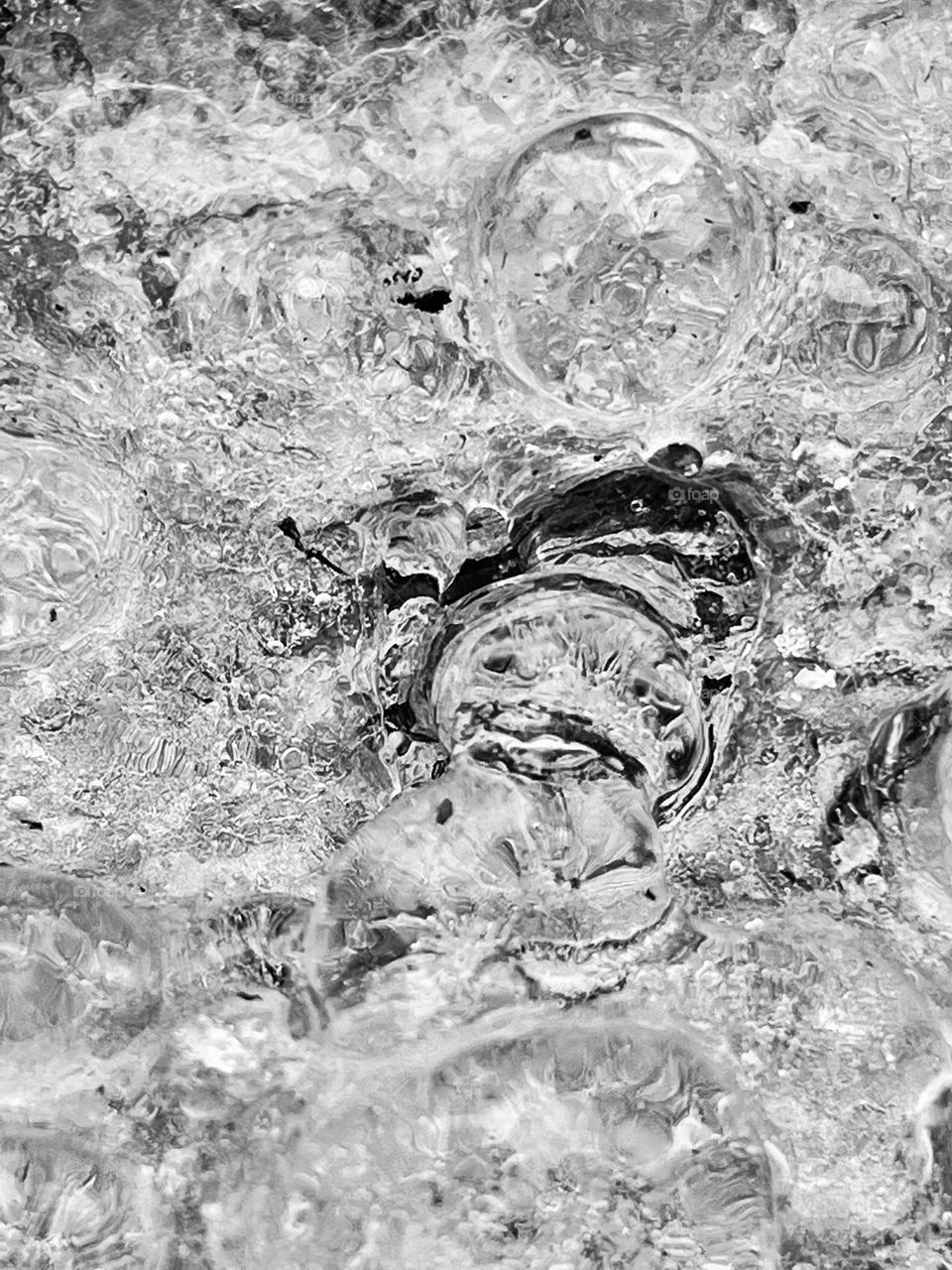 A macro shot of ice bubbles on a wooden platform.