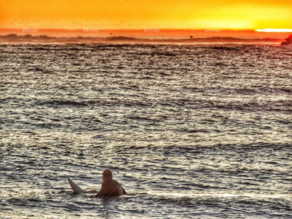 California Surfer Waiting For A Wave At Sunset. Surfing At Sunset