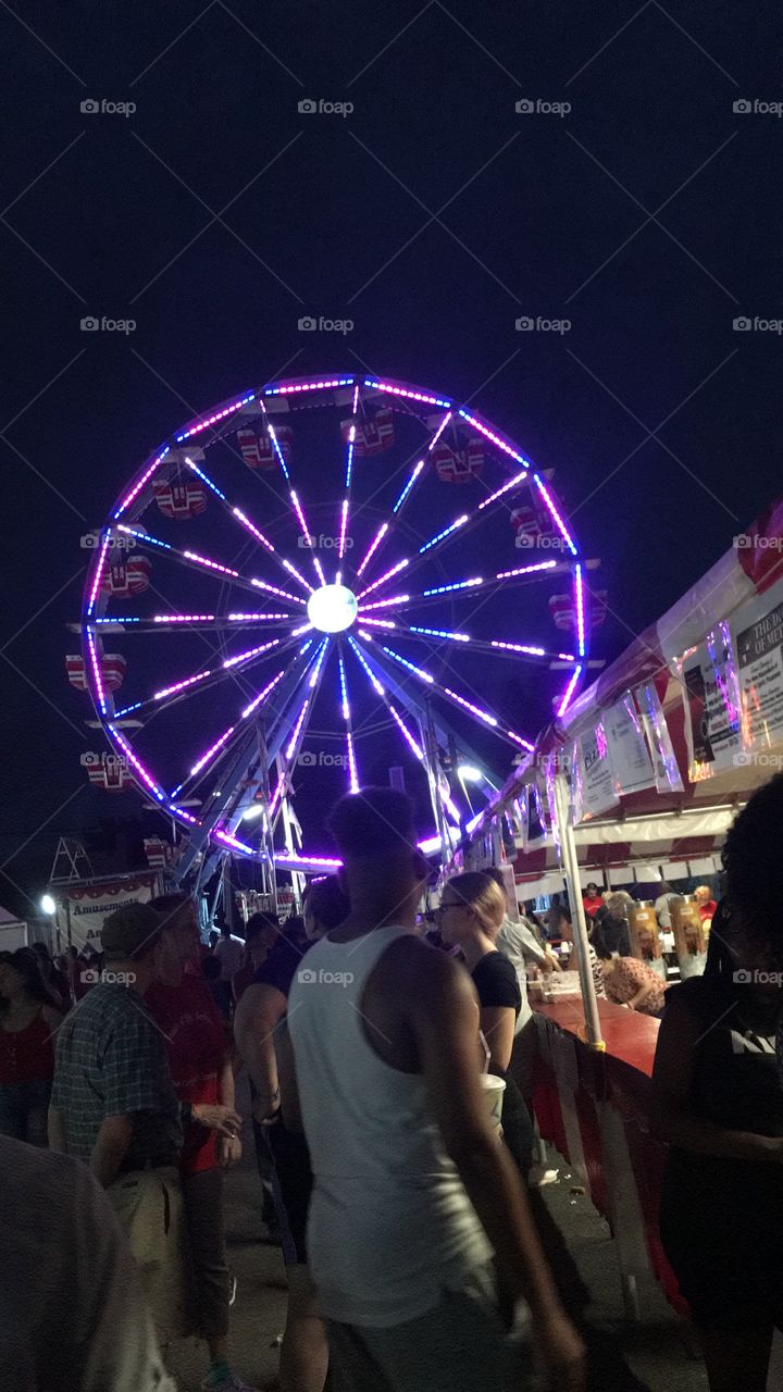 Purple Ferris wheel in a community carnival 