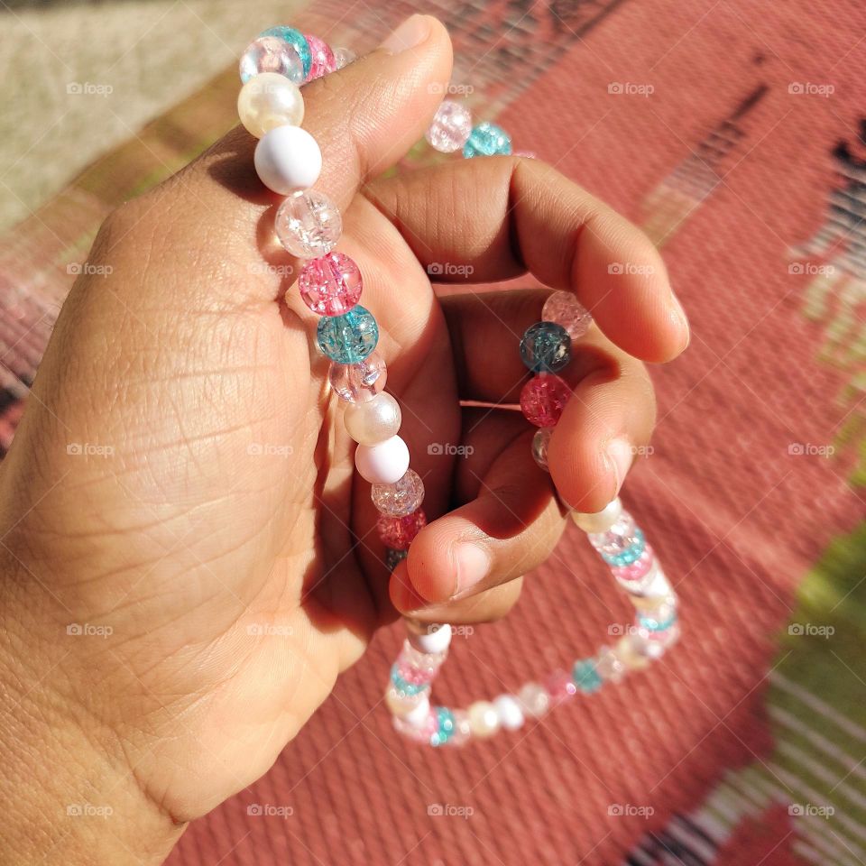 reflection of sunrays on beads and shadow