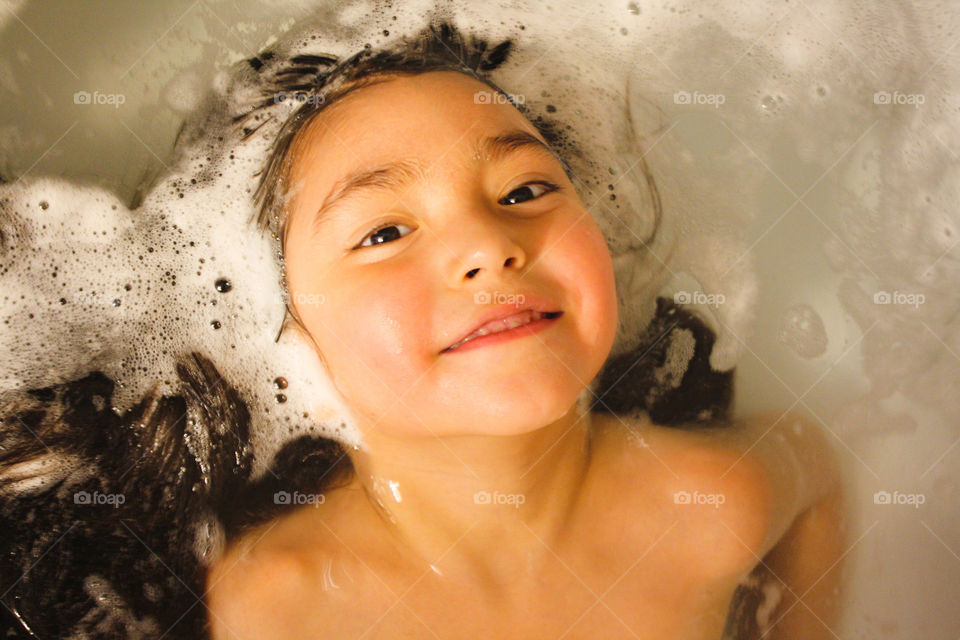 Cute little girl is taking a bath